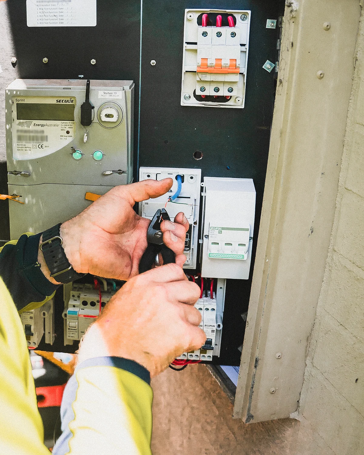 Electrician working on electricity panel