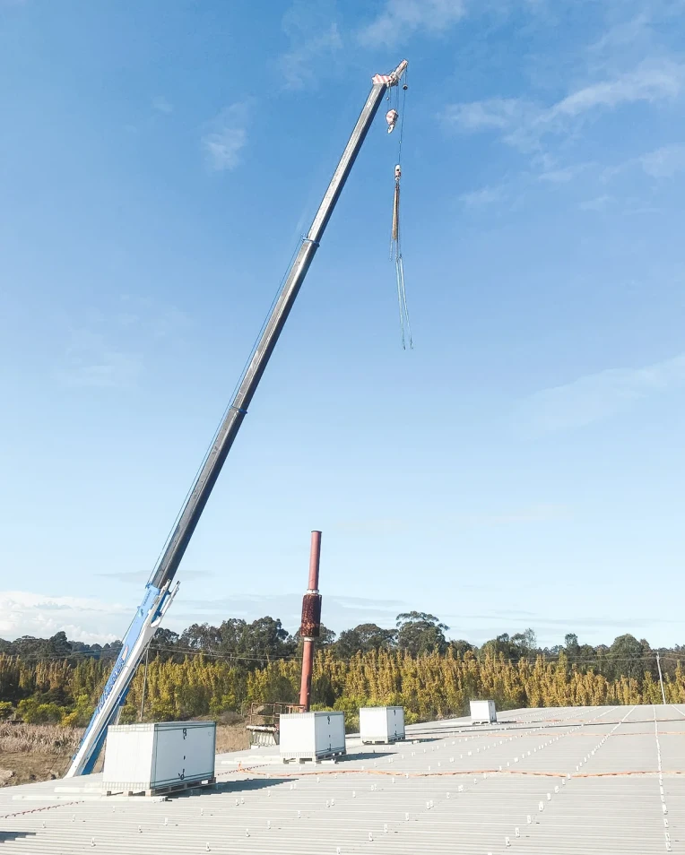 Crane lifting solar panel pallets